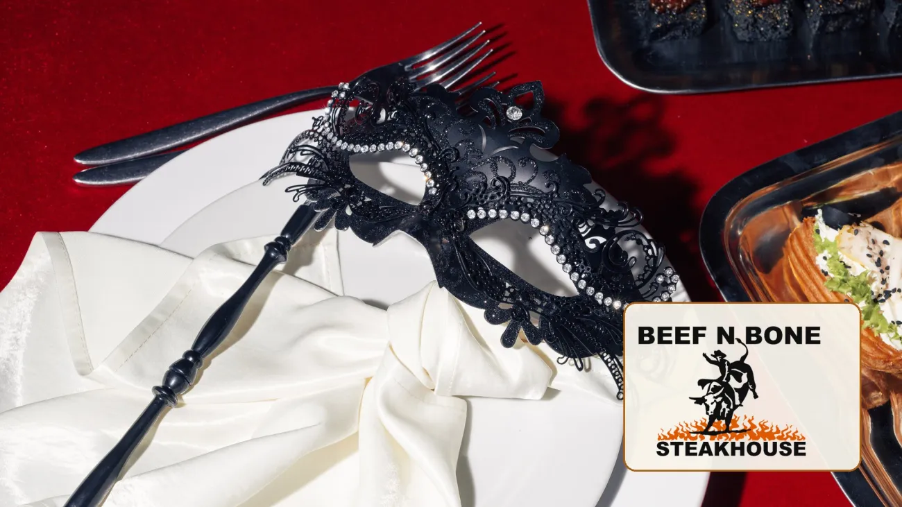 Black masquerade mask on a dinner plate, with the Beef N Bone Steakhouse logo