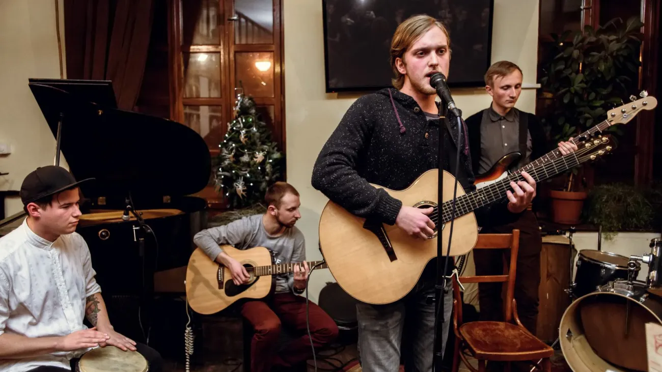 Acoustic band of young men playing and singing on stage