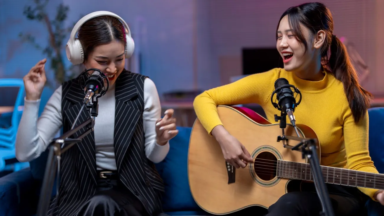 Two women playing music and singing
