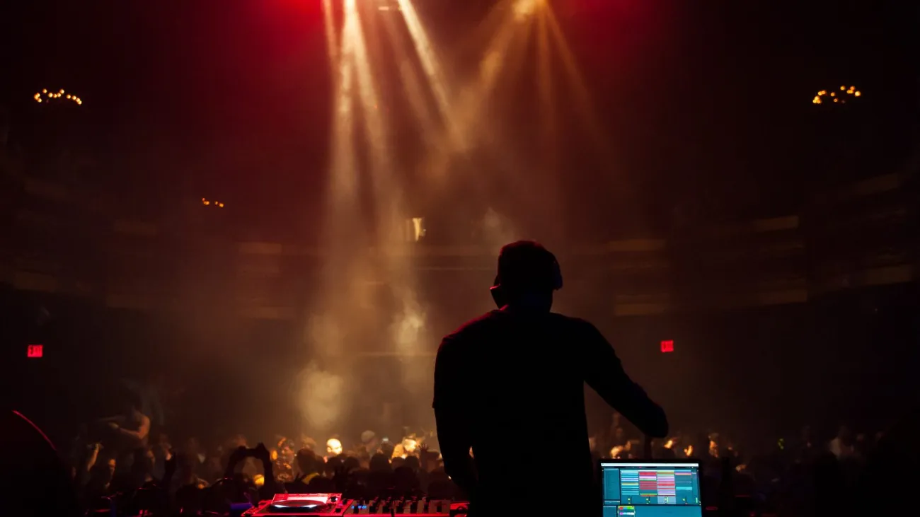 Silhouette of a DJ performing at a concert