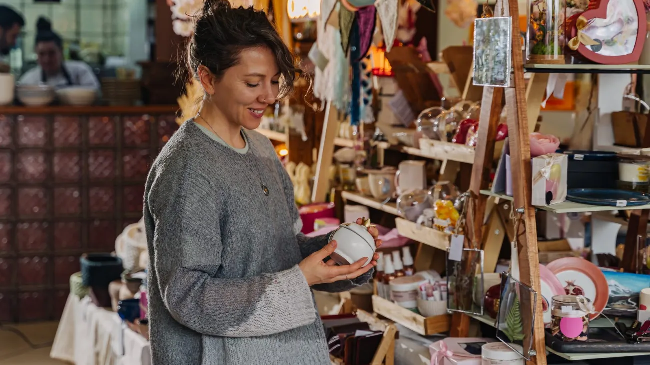 Woman browsing handmade items at a craft fair