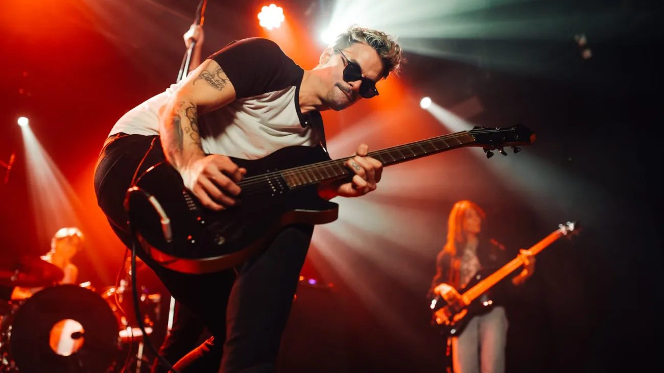 Guitarist performing live with his band