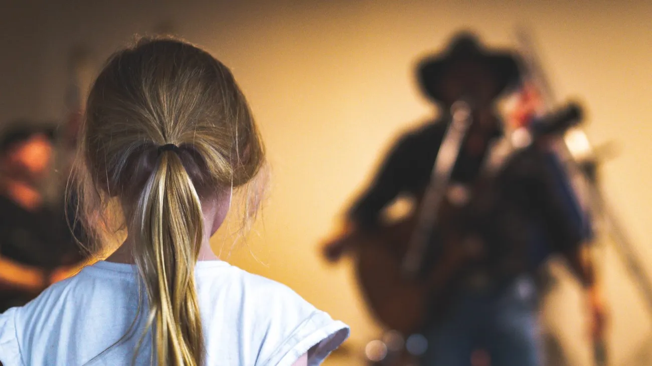 Musician singing country music for a listener