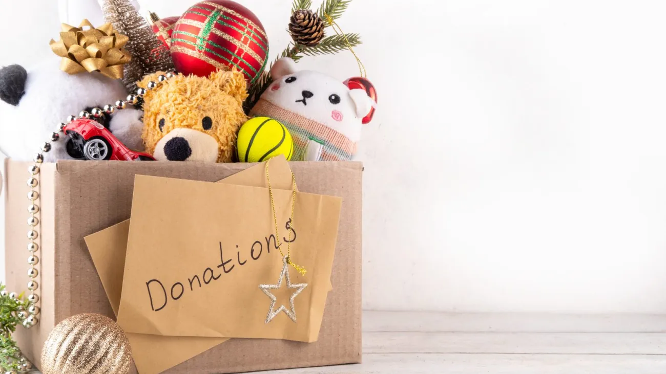 Donating gifts and toys to charity for Christmas holiday concept. Tradition holiday toys drive, cardboard box full with 