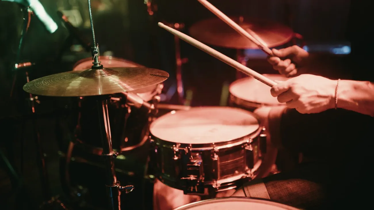 Drummer playing a drum kit at a club show