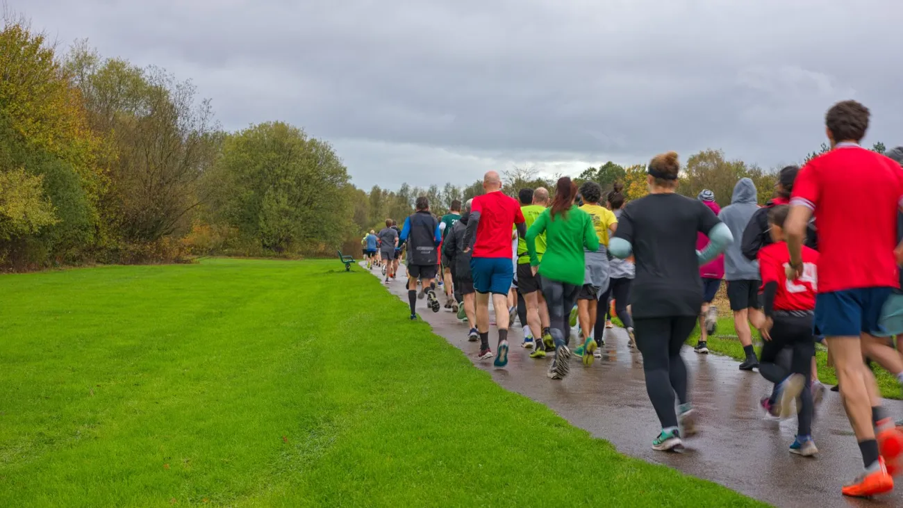 Large group of runners on a road race course