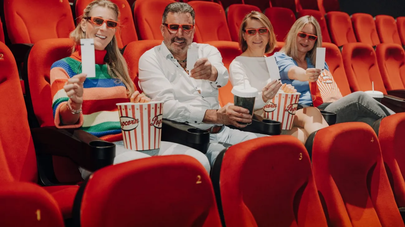 Audience enjoying a film screening with popcorn