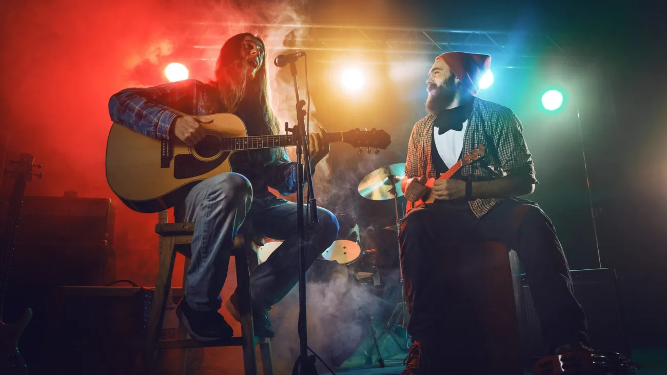 The musician plays an acoustic guitar