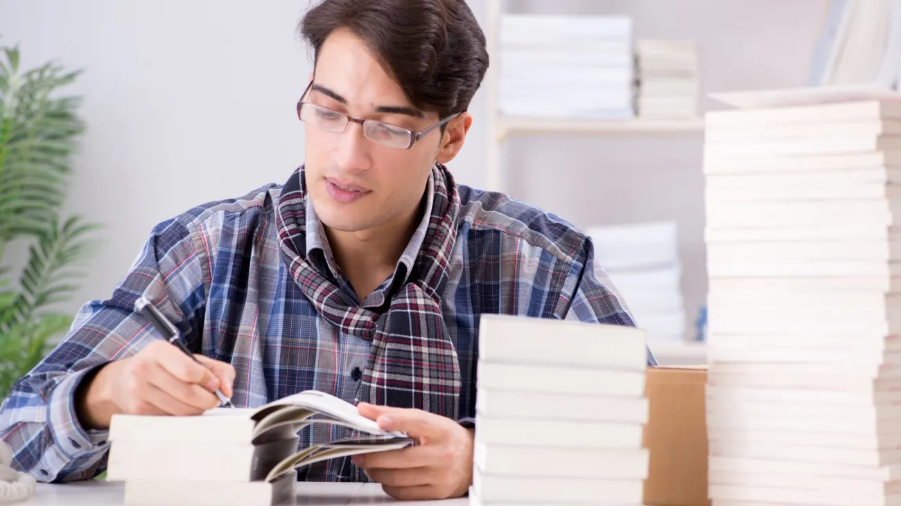 Writer presenting his books to an audience