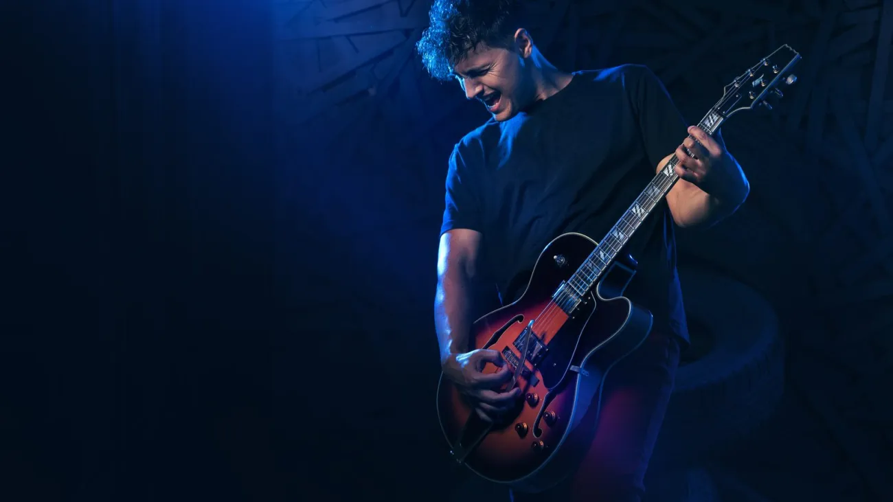 Band with guitar, bass and drums performing on stage