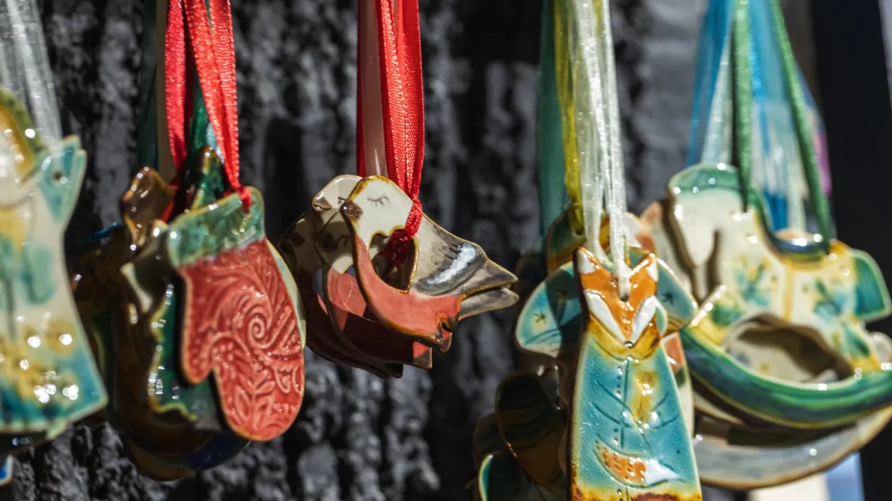 Handmade ceramic Christmas ornaments hanging at a holiday fair