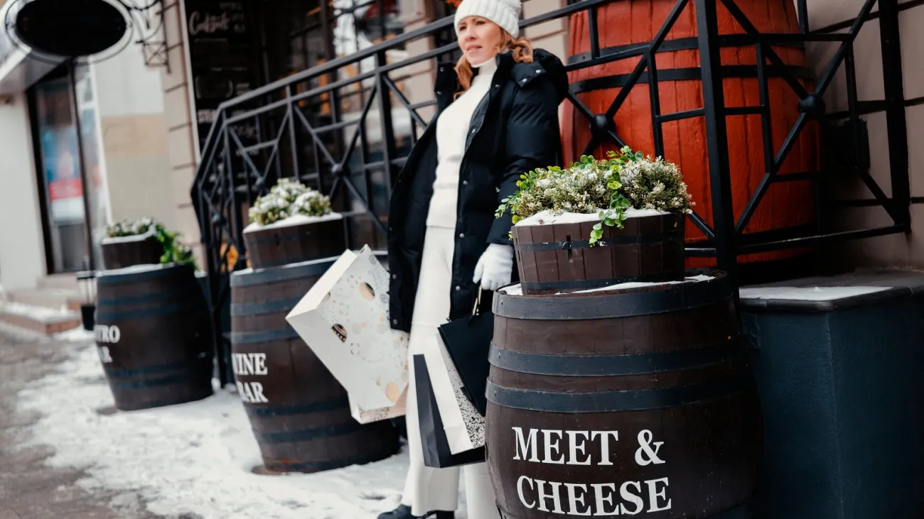 Woman with shopping bags at a wine bar