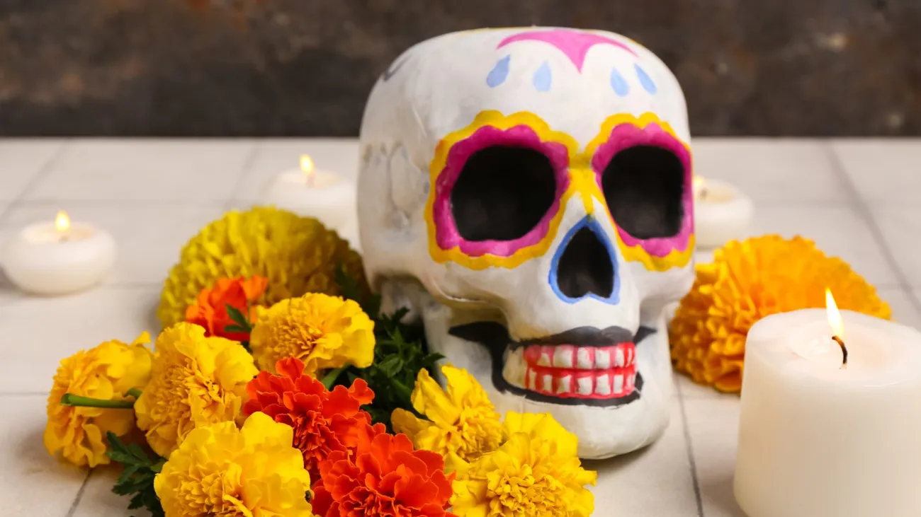 Painted skull with marigolds and candles