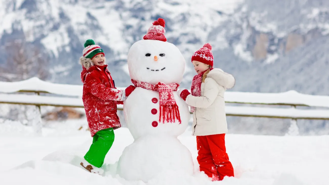 Child building a snowman