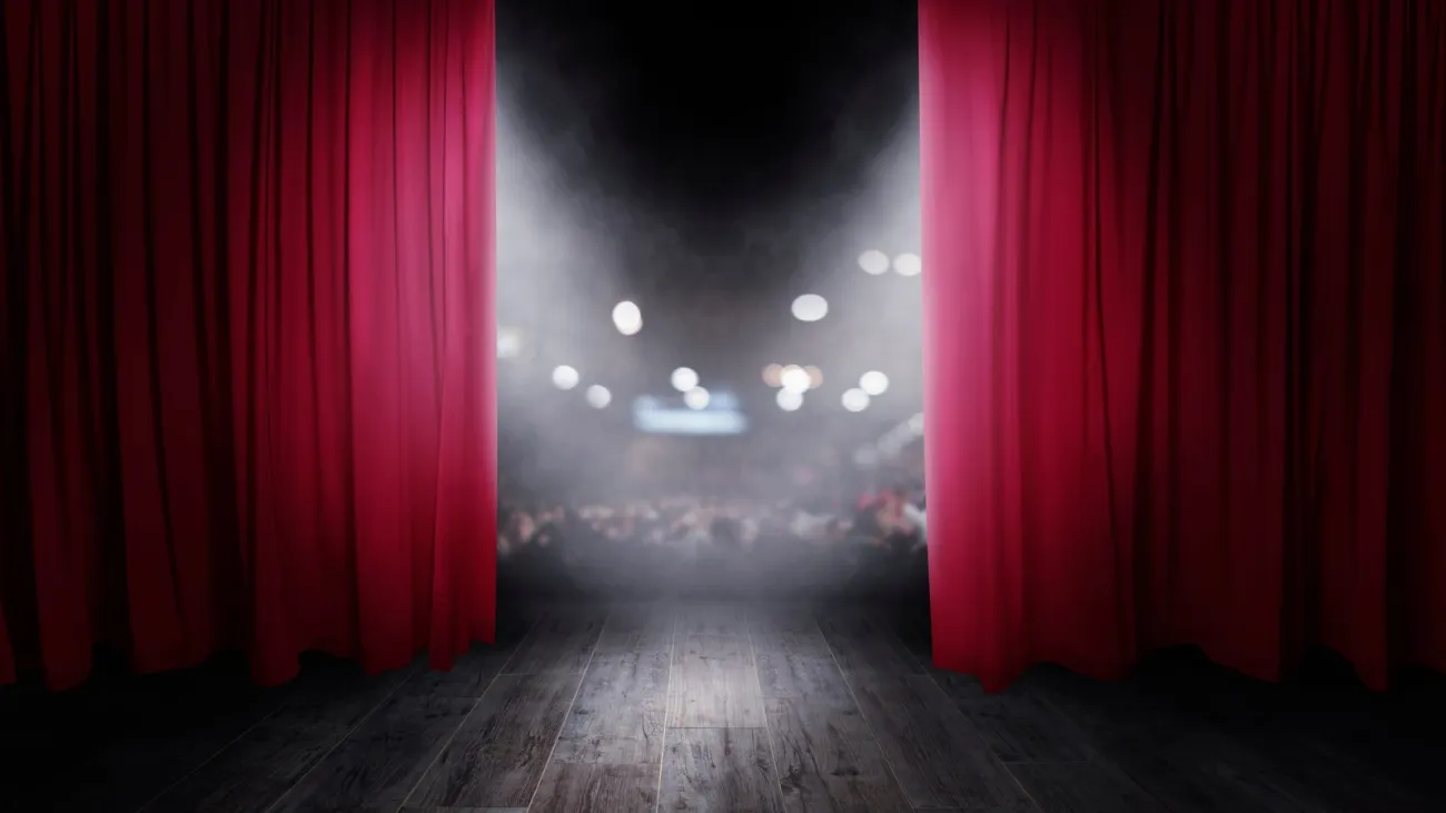 Red theater curtains opening for a show