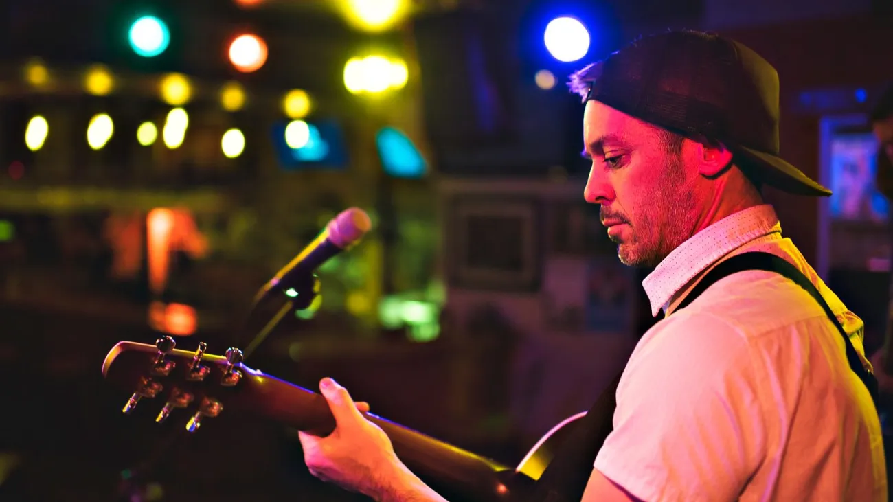 Man playing guitar at a bar