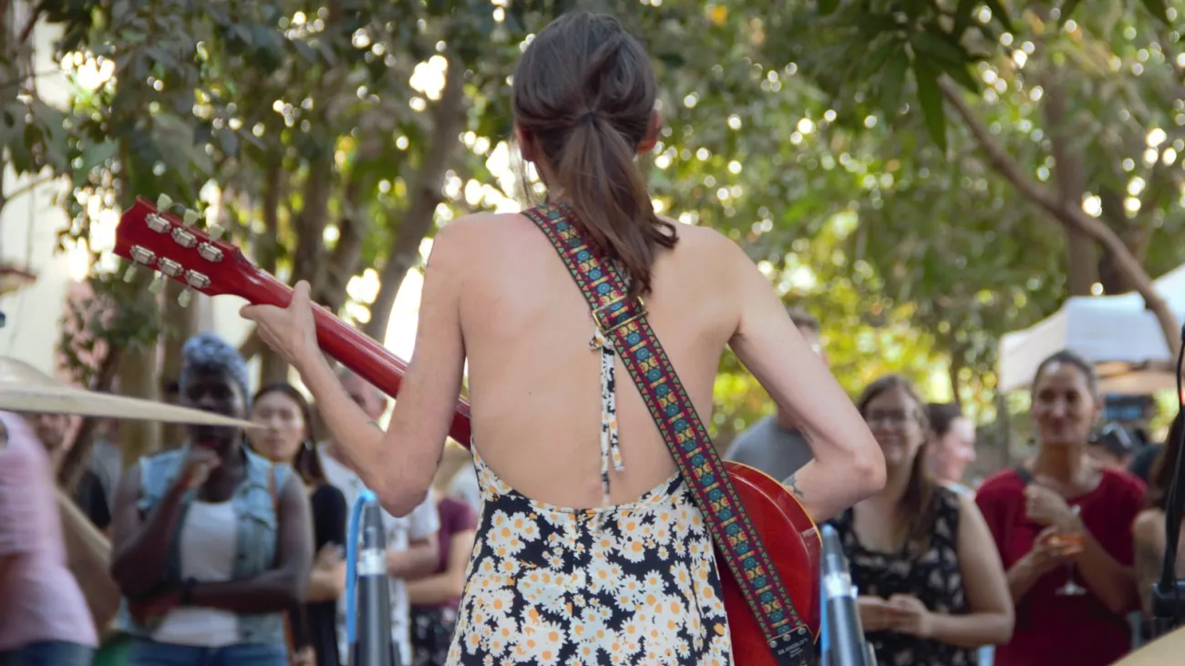 Female singer-songwriter performing live