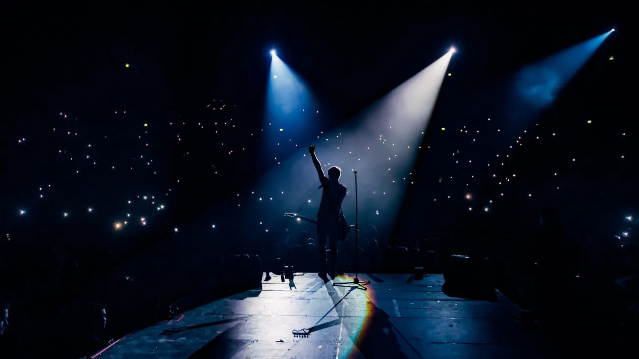 Guitarist playing in front of a crowd