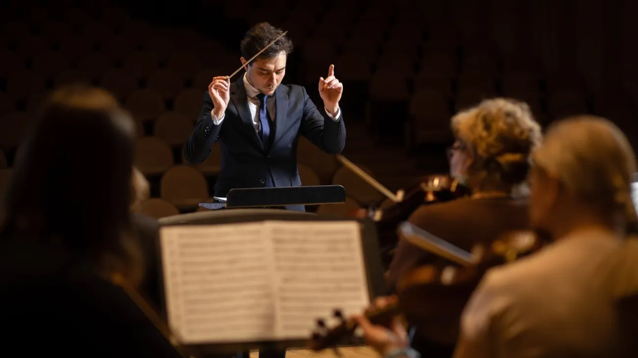 Conductor leading a symphony orchestra