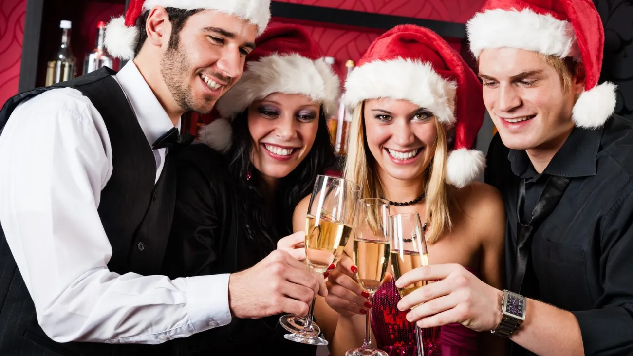 Friends toasting at a Christmas party in a bar