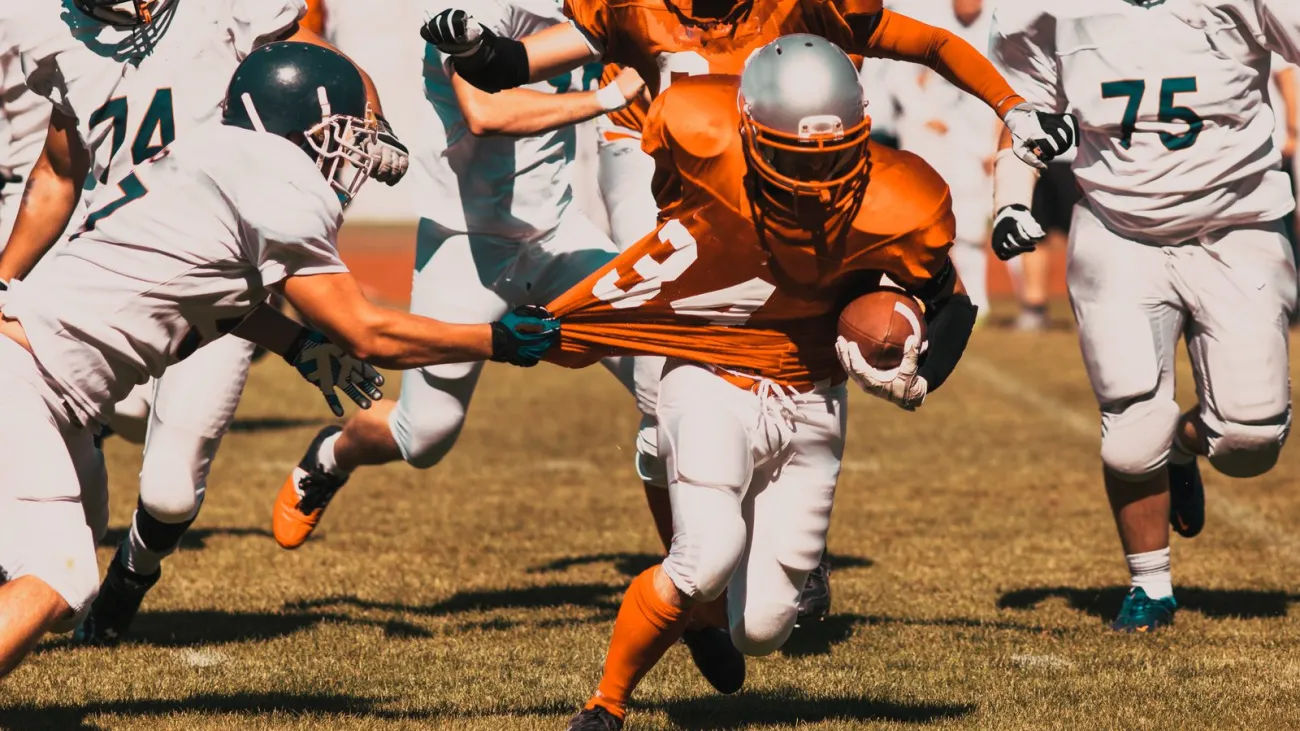 American football players fighting for the ball