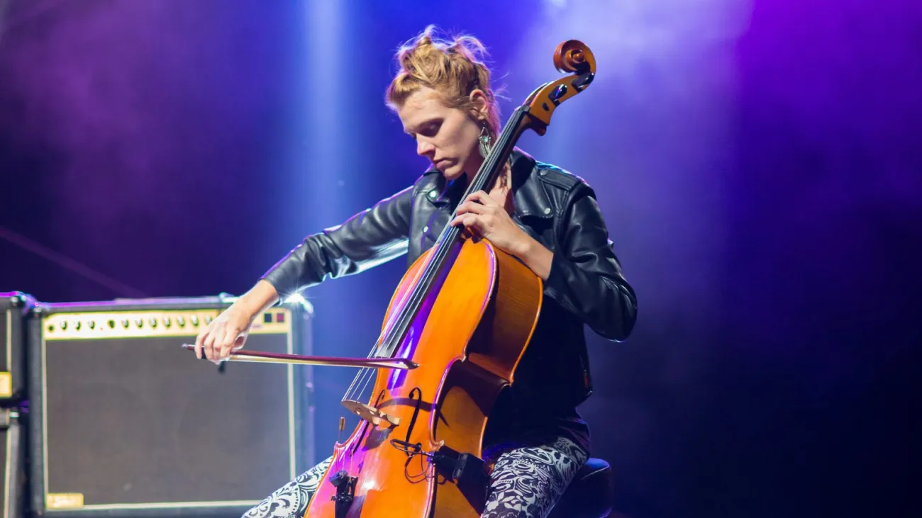 Woman playing cello at an evening concert