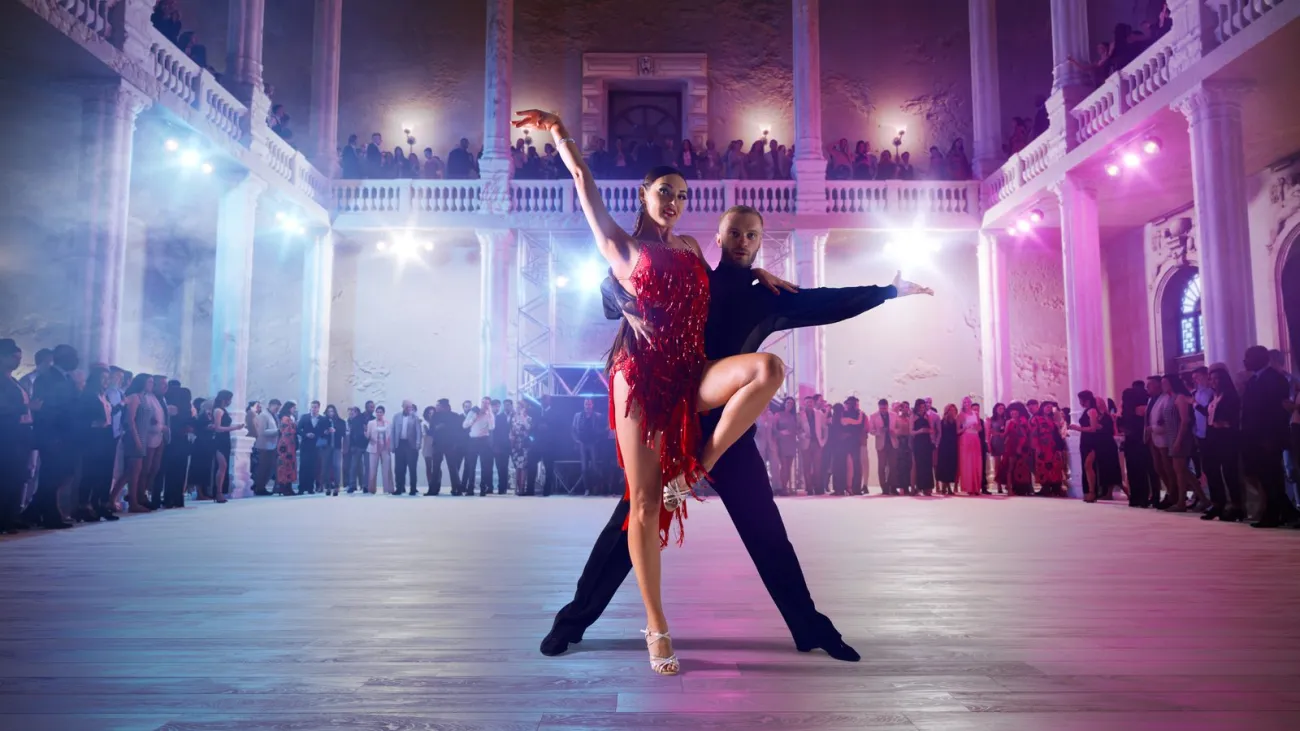Couple dancers perform latin dance on large professional stage. Ballroom dancing