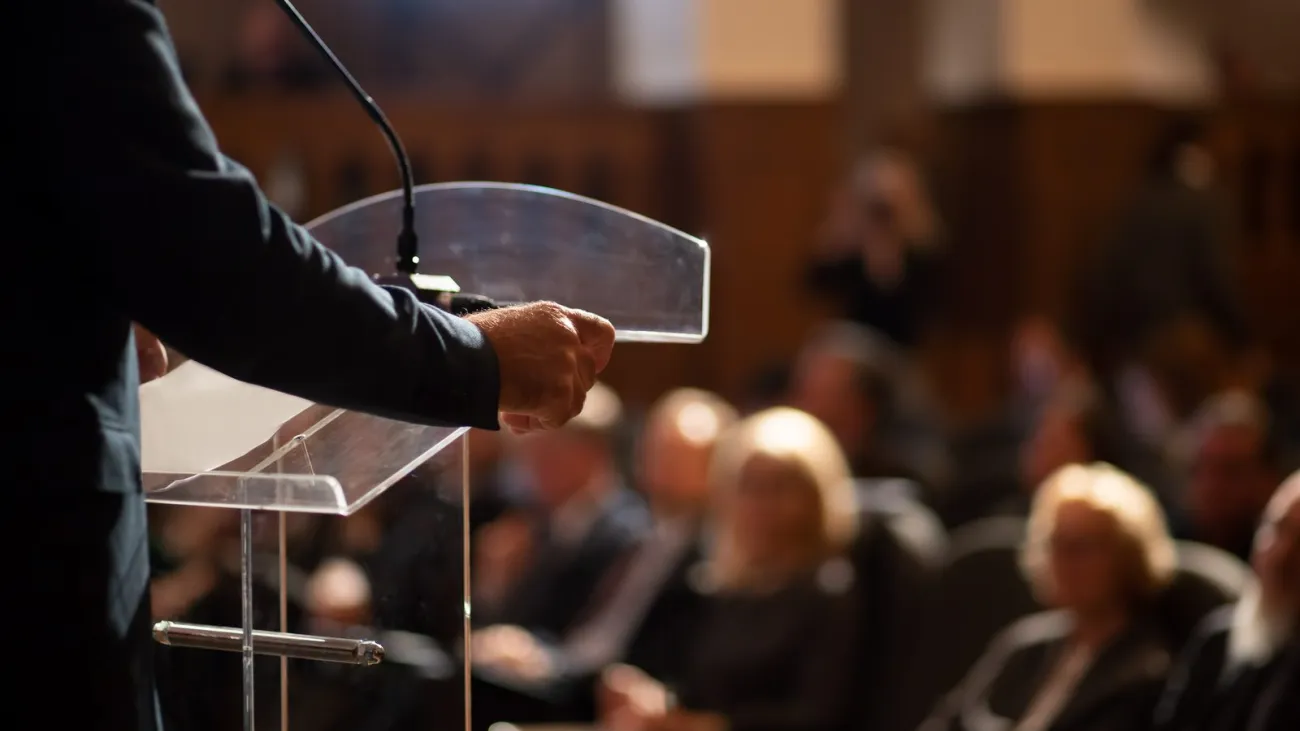 Man giving a lecture in front of an audience