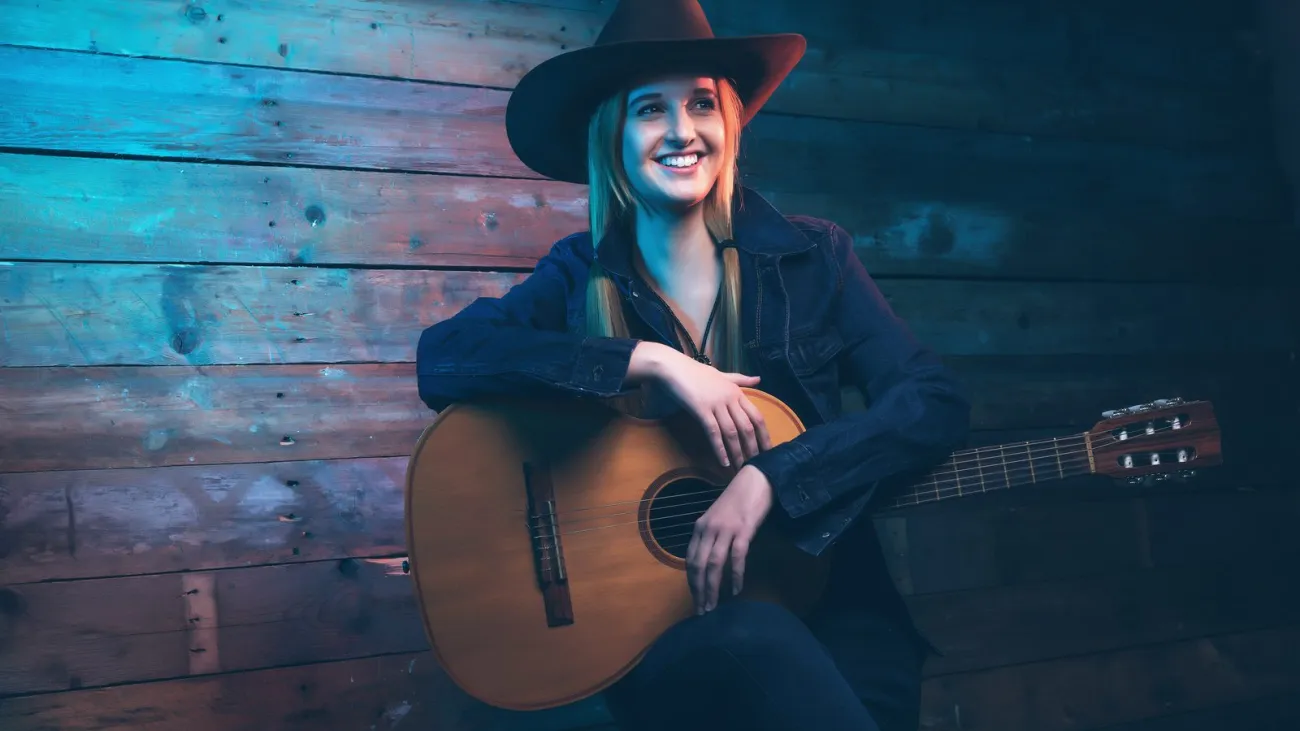 Country singer in a cowboy hat with an acoustic guitar
