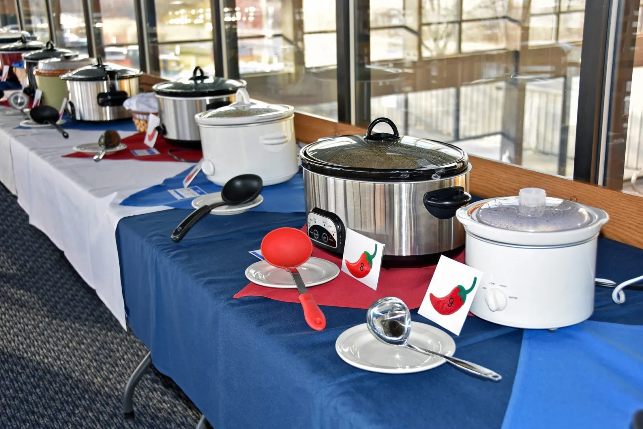 A row of slow cookers at a chili cook-off