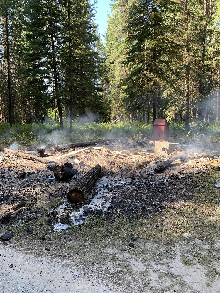 The burned remains of the Fork Creek Cabin at Glacier National Park