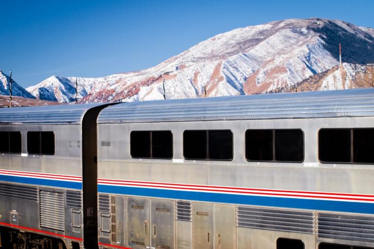Amtrak against mountain backdrop