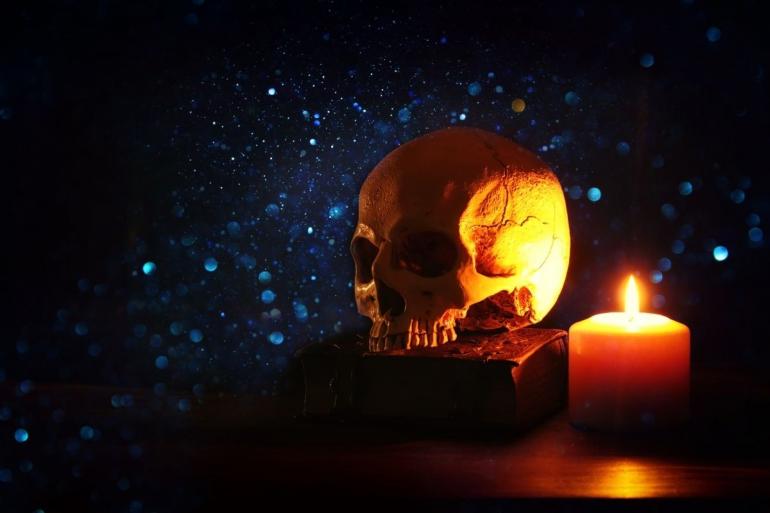 skull on desk with book