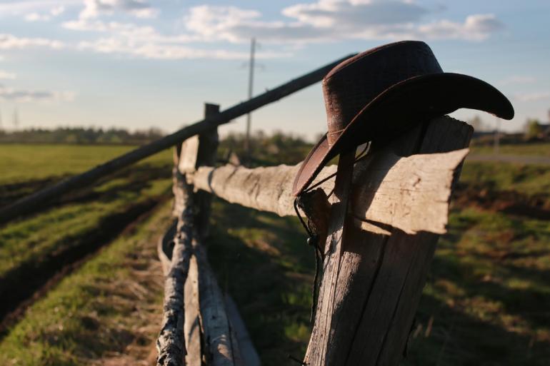 Cowboy hat on fence