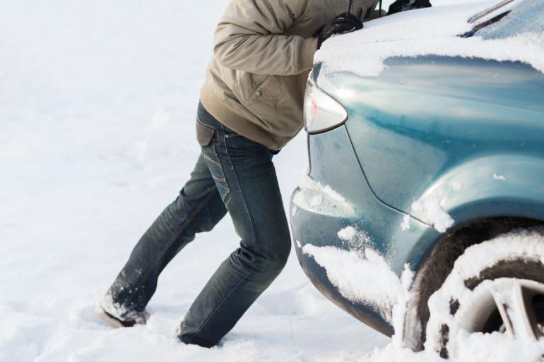 Pushing car stuck in snow