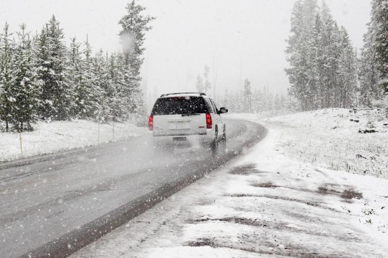 Car driving away in the snow