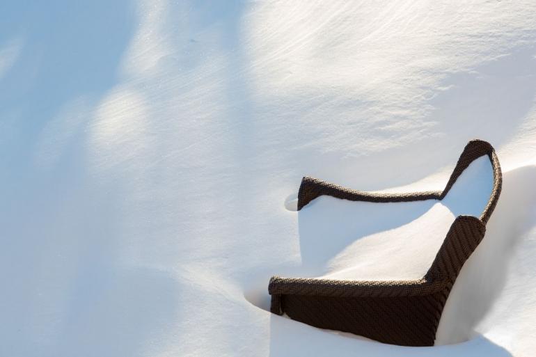 Garden chair buried in snow