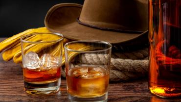 Still-life of cowboy hat with booze