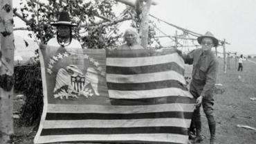 Two Chippewa-Cree Men Posing with 1803 Peace Flag