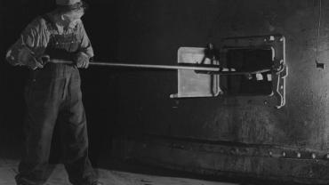 Man cleaning zinc furnace in Great Falls