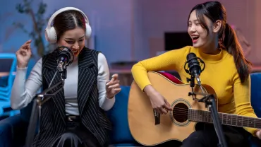Two women playing music and singing
