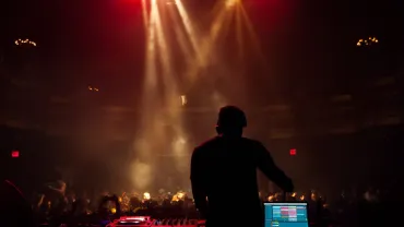 Silhouette of a DJ performing at a concert