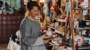 Woman browsing handmade items at a craft fair