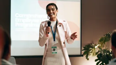 Business woman, seminar and training for speaker in conference room for wellness presentation. Education, forum speech a