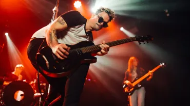 Guitarist performing live with his band