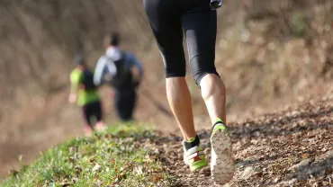 Runner on a mountain trail during a trail race