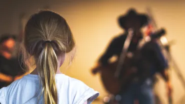 Musician singing country music for a listener