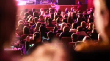 Large audience seated in a grand theater