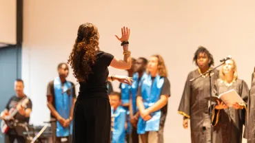 Conductor leading a choir in concert