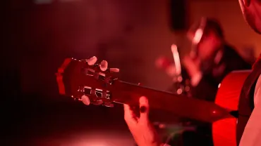 Close-up of a guitar during a live performance
